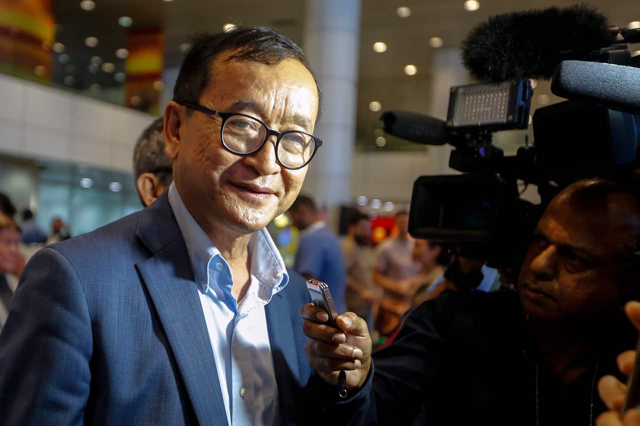 Self-exiled former Cambodian opposition leader Sam Rainsy speaks to journalists after landing at Kuala Lumpur.