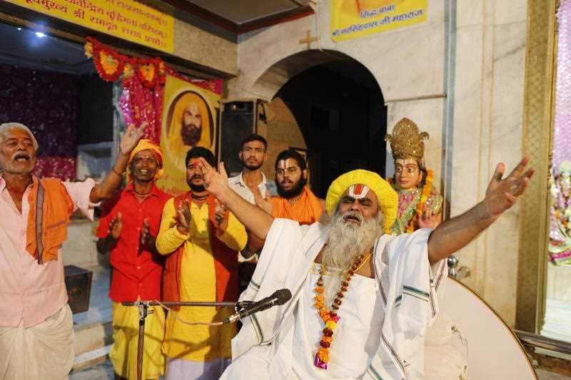 Hindu holy man Shri Narsingh Das Maharaja, right, celebrates after a verdict in a decades-old land title dispute between Muslims and Hindus, in Ayodhya, India