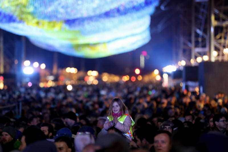 Visitors attend the celebrations of the 30th anniversary of the fall of the Berlin Wall at the Brandenburg Gate in Berlin