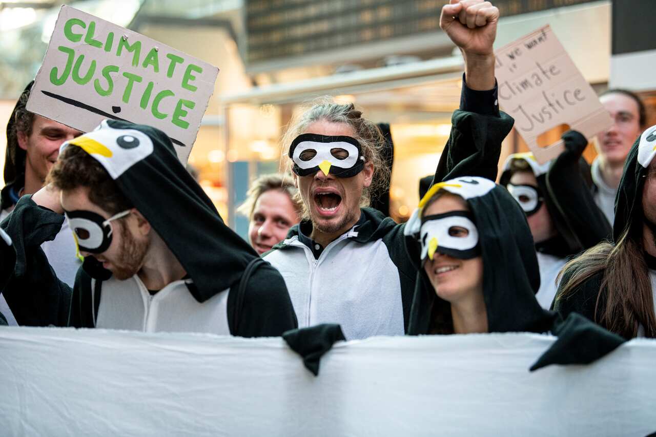Demonstrators block the main hall of Tegels airport in Berlin during a protest to draw attention to the climate damage caused by air traffic.