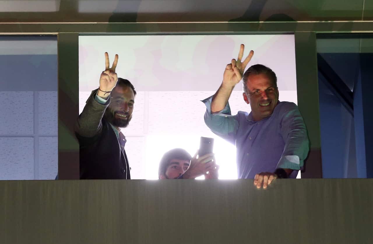 President of far-right party Vox, Santiago Abascal (L) and Secretary-General of Vox, Javier Ortega Smith (R), flash the V-sign as they greet supporters.