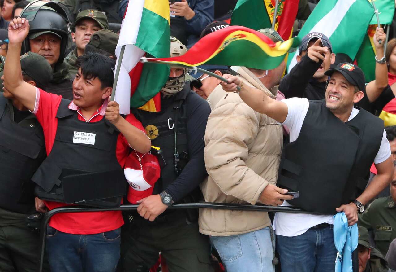 Civic leaders Luis Fernando Camacho (R) and Marco Pumari (L) celebrate with Bolivians the resignation of President Evo Morales