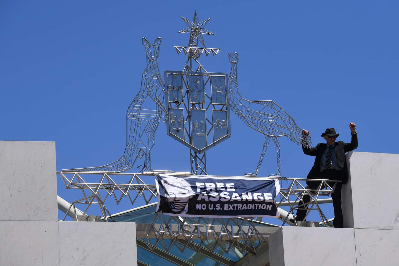 The man shouted "Free Julian Assange" from the top of Parliament House.