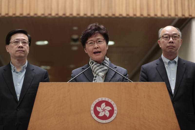 Hong Kong Chief Executive Carrie Lam, center, speaks during a press conference in Hong Kong, Monday, Nov. 11, 2019