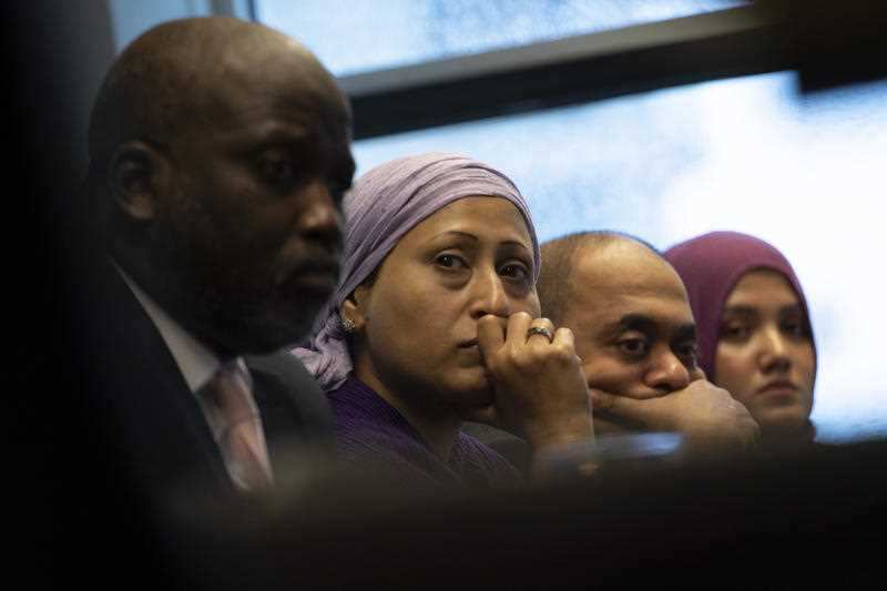 Representatives of the Rohingya community and Gambia's Justice Minister Aboubacarr Tambadou, left, listen to testimony during a press conference in The Hague
