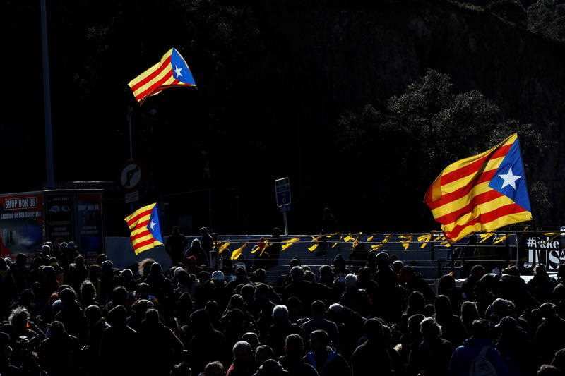 Hundreds of people block the road that connects Spain and France, near the border in Le Perthus, France, 11 November 2019