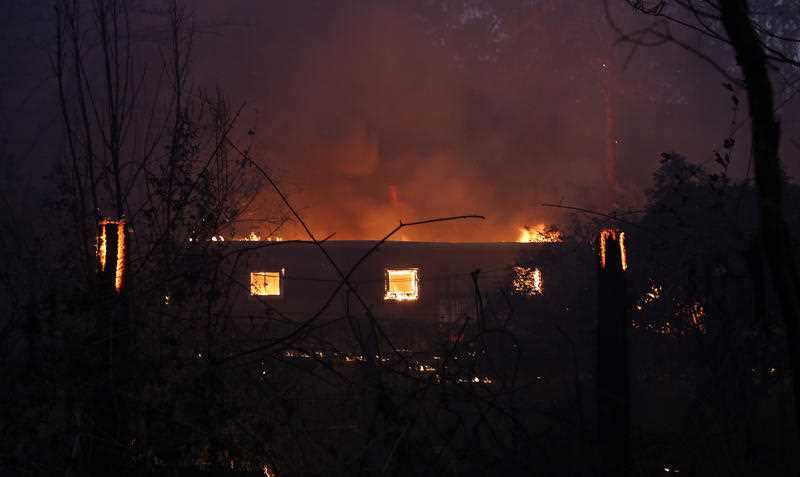 A house on fire near the Pacific Highway, north of Nabiac in the Mid North Coast region of NSW, Tuesday, November 12, 2019. 