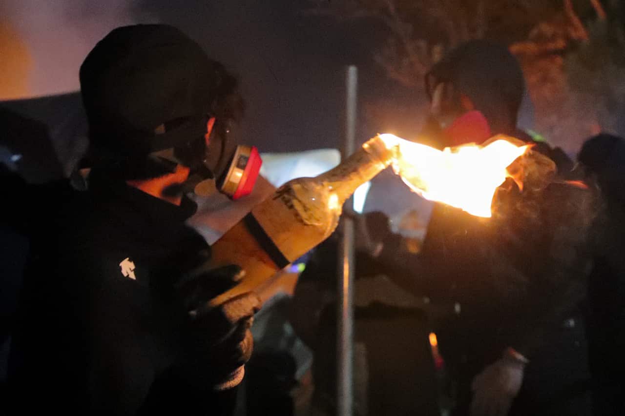 A student holds a molotov cocktail during clashes at the Chinese University.