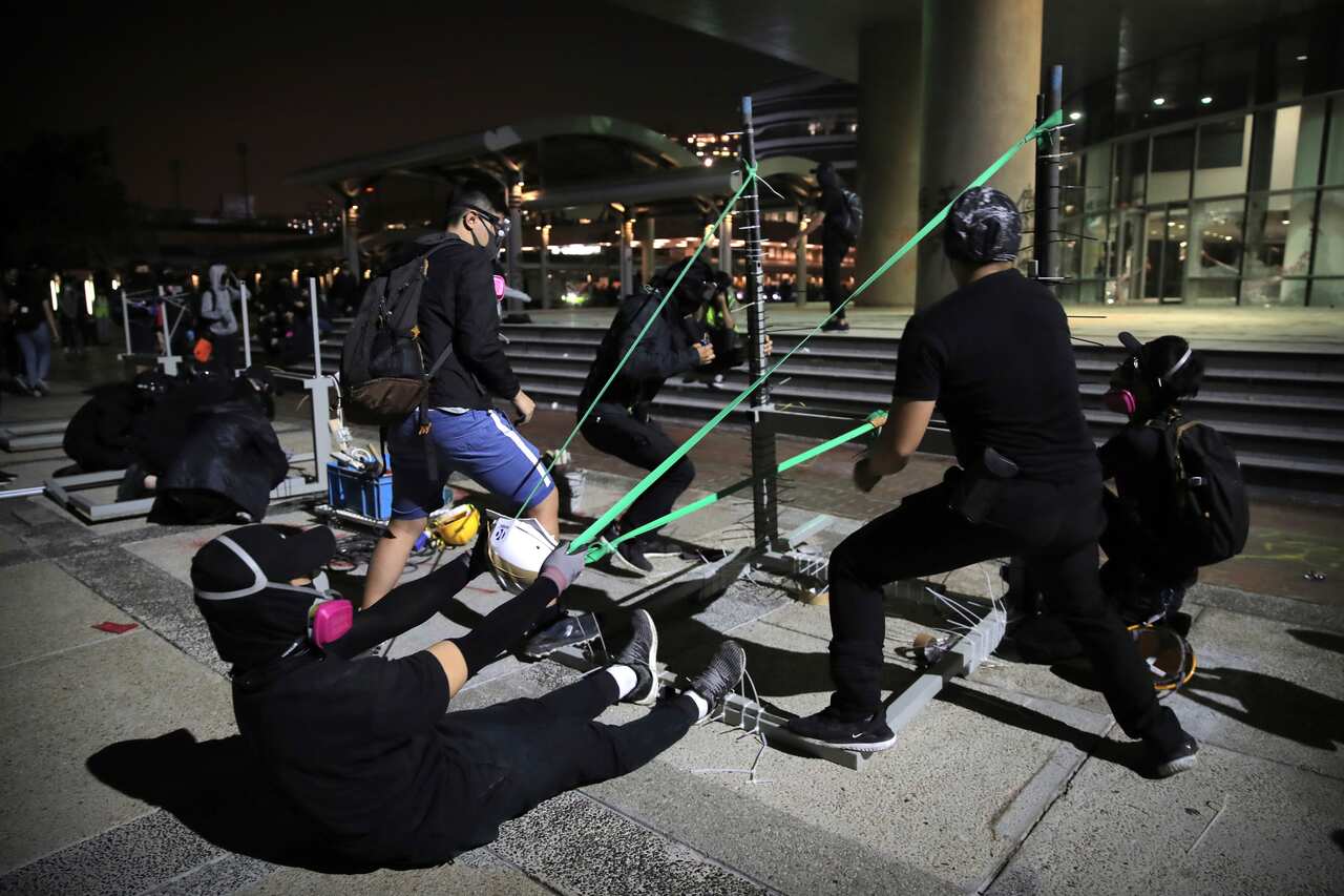 Protestors practice using a homemade slingshot at Hong Kong Polytechnic University.