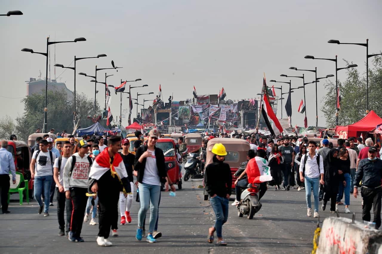 Protesters sit-in on a bridge leading to the Green Zone government areas during ongoing protests in Baghdad, Iraq, Thursday, Nov. 14, 2019. (AP Photo/Khalid Mohammed)