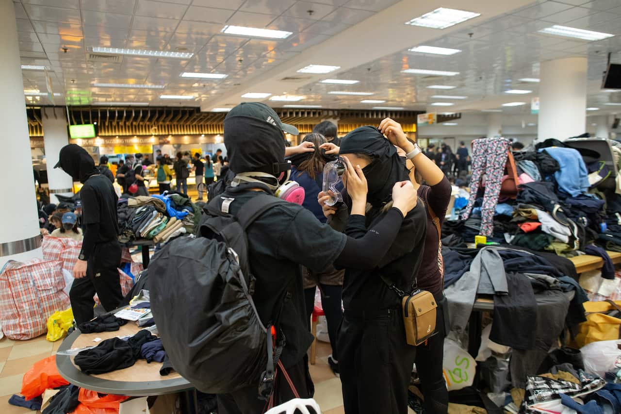A pro-democracy protester tries a face mask in the canteen of the Hong Kong Polytechnic University.