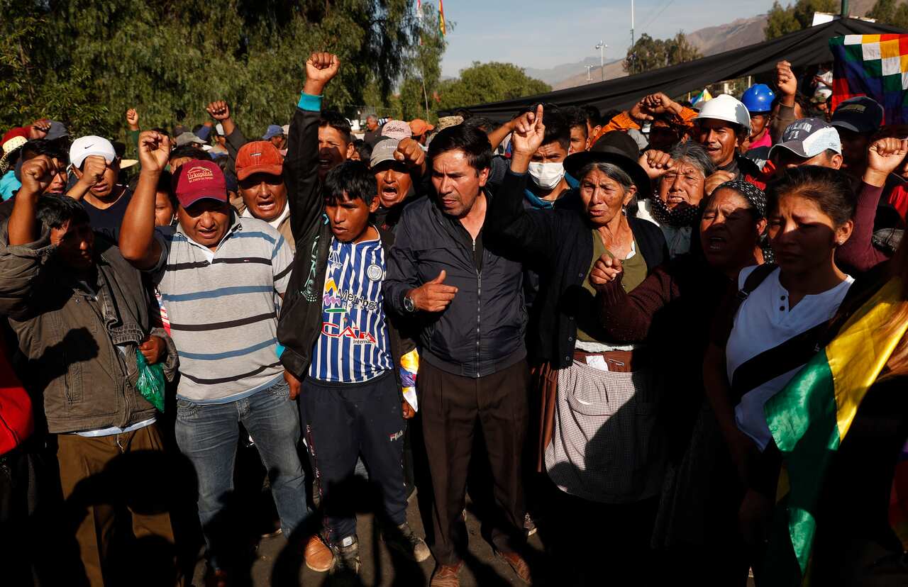 People protest next to the coffin of a supporter of former President Evo Morale.