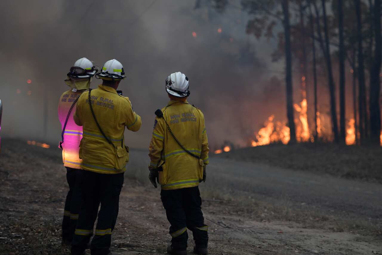 NSW Rural Fire Service crews fight a fire as it burns close to property on Wheelbarrow Ridge Road at Colo Heights, north-west of Sydney.