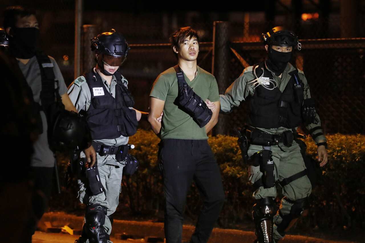 Police arrest a protester after he tried to escape from Polytechnic University during the siege. 