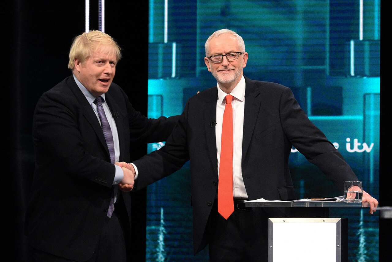Boris Johnson and Jeremy Corbyn shaking hands during a head-to-head debate last month.