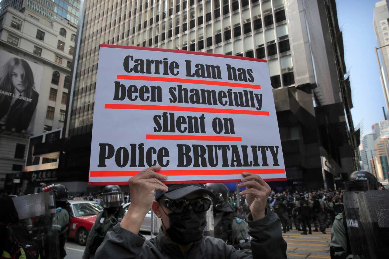 A protester holds a placard during a demonstration in the financial district of Hong Kong.