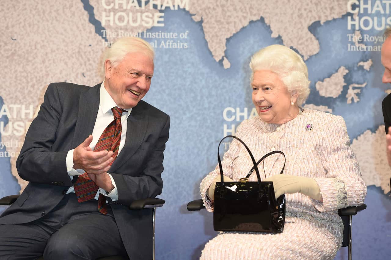 Britain's Queen Elizabeth II sits alongside Sir David Attenborough at the Royal institute of International Affairs, Chatham House, London.
