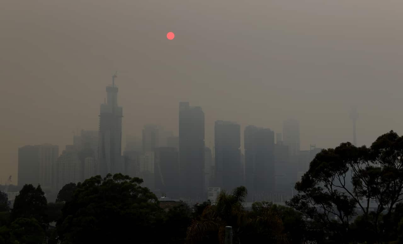 The Sydney skyline is seen from Balmain as winds blow smoke from bushfires over the CBD.