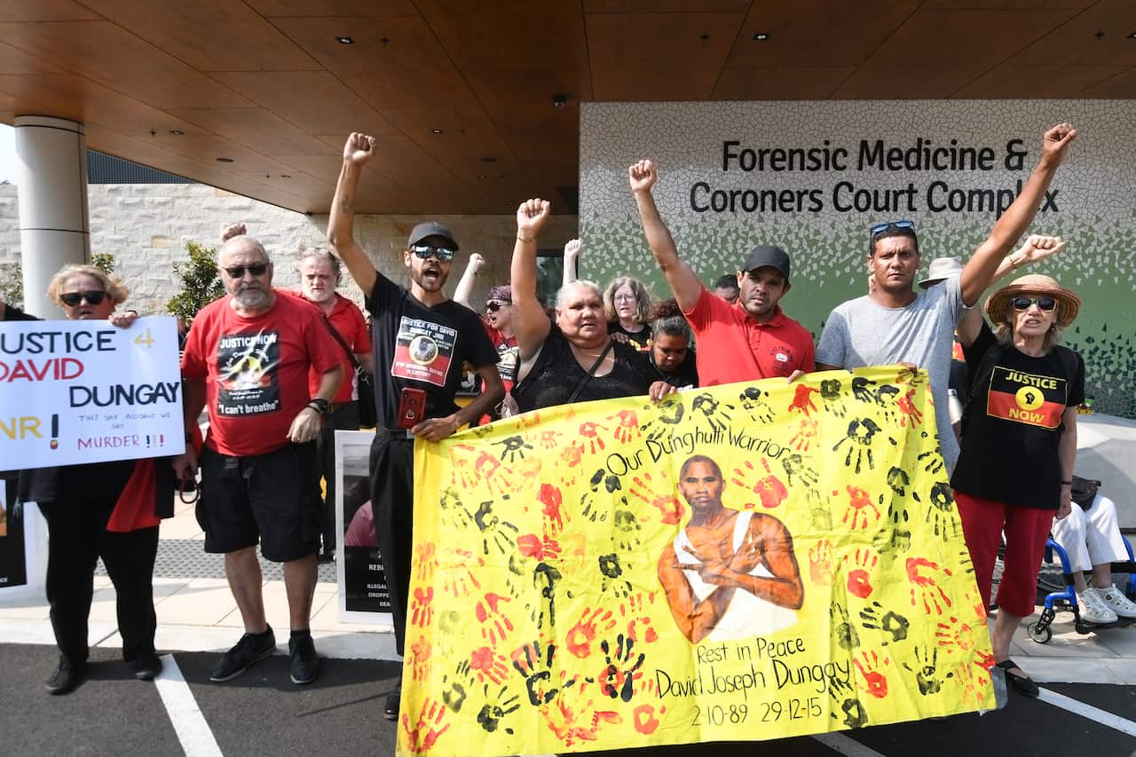 Supporters gather outside the Lidcombe Coroner's Court in Sydney.