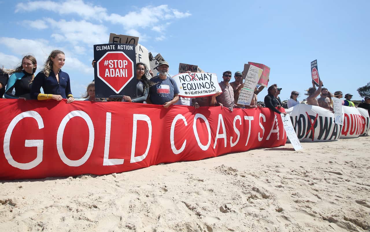 Anti-oil drilling protesters are seen at Currumbin on the Gold Coast.