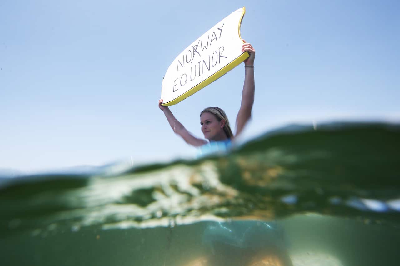 Anti-oil drilling protesters are seen at Currumbin on the Gold Coast.