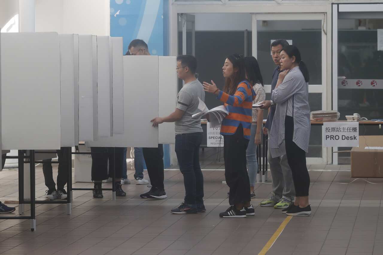 Staff members prepare a polling station for the 2019 District Council Ordinary Election in Hong Kong.