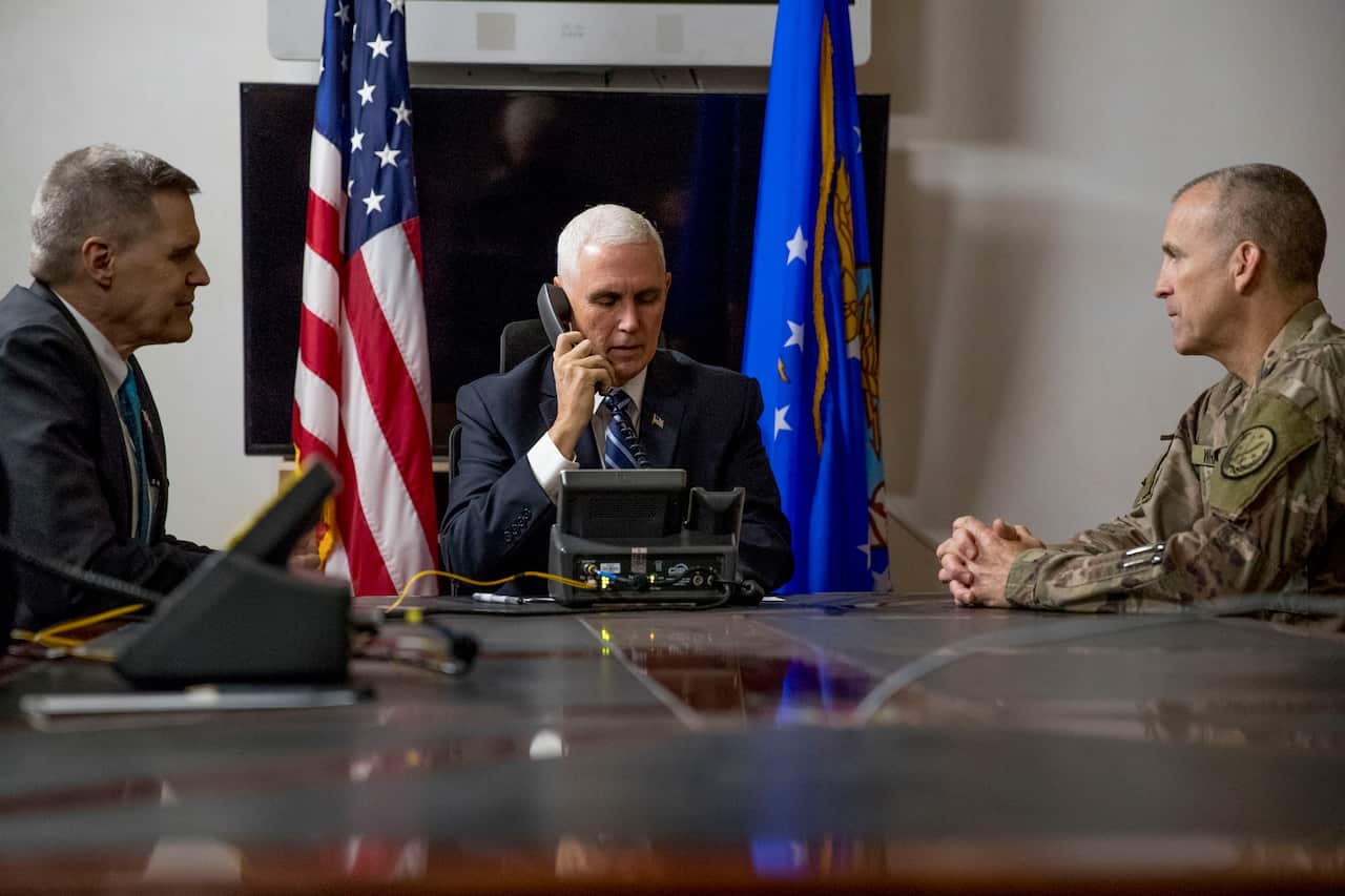 US Vice President Mike Pence, U.S. Ambassador to Iraq Matthew Tueller and Lt. Gen. Pat White take a phone call from the Iraqi Prime Minister.
