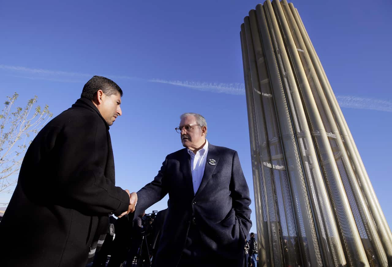 El Paso Mayor Dee Margo shakes hands with Walmart manager Robert Evans during the dedication ceremony.