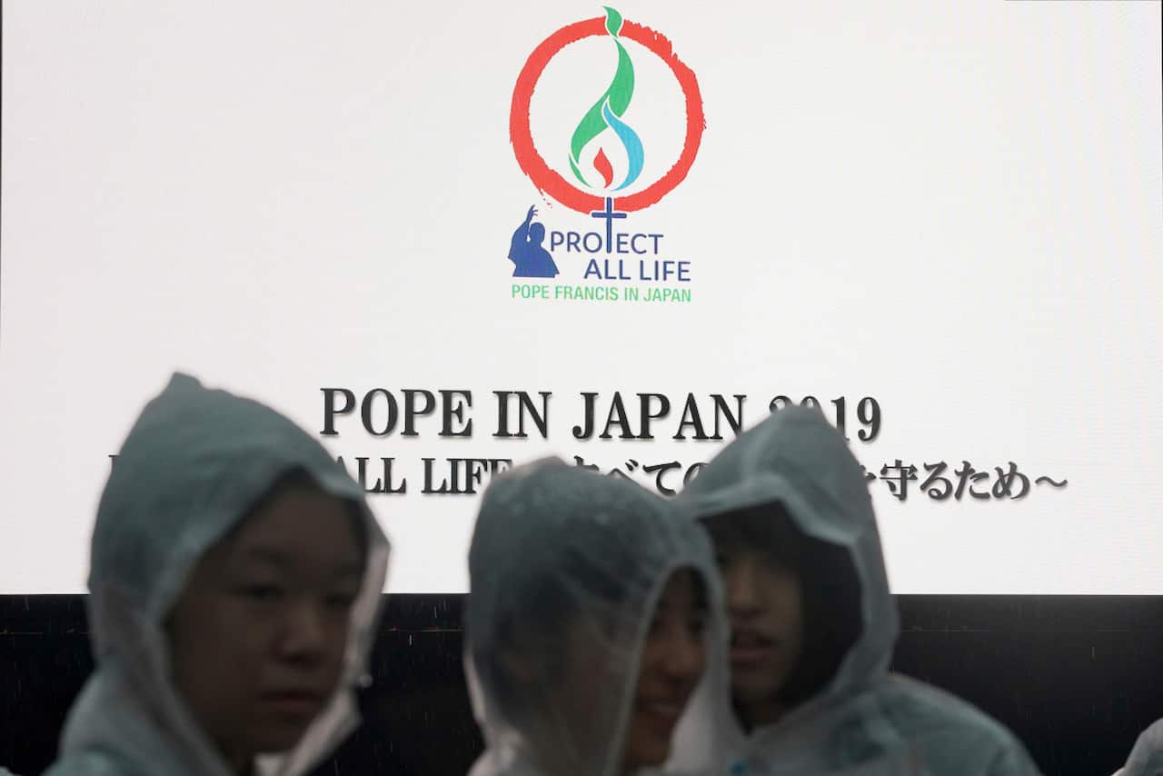 The faithful wait for Pope Francis at the Atomic Bomb Hypocenter Park.