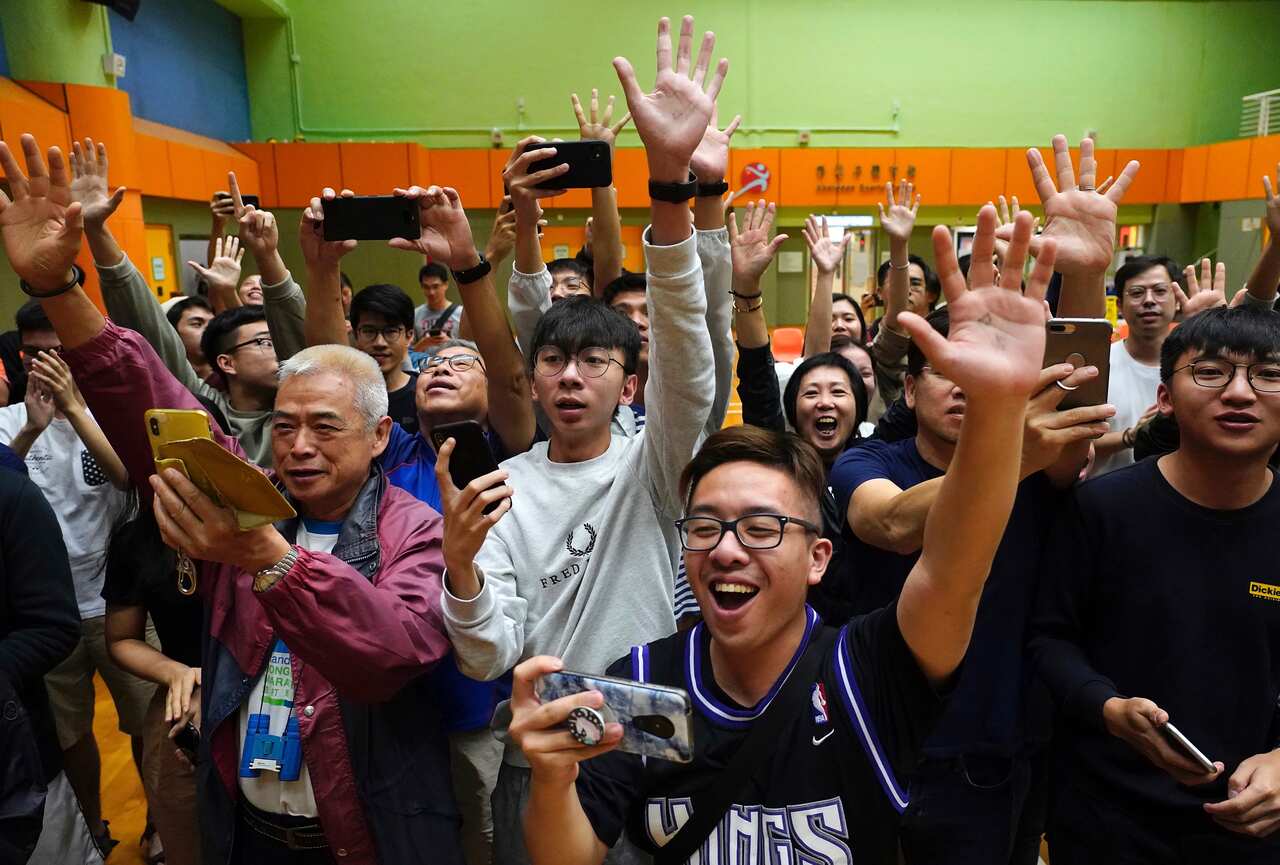 Supporters of pro-democracy candidate Angus Wong celebrate after he won in district council elections in Hong Kong, Monday, 25 November, 2019. 