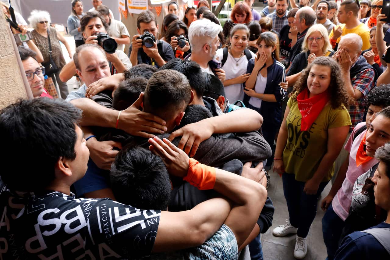 Supporters of the alleged sex abuse victims from the Antonio Provolo Institute for Deaf and Hearing Impaired Children embraced outside court.