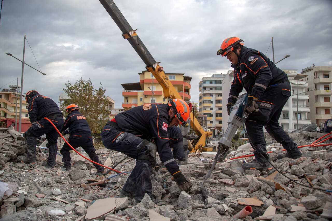 Turkish rescuers search at a collapsed building in Durres, western Albania.