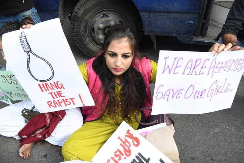 A woman holds placards as she protests