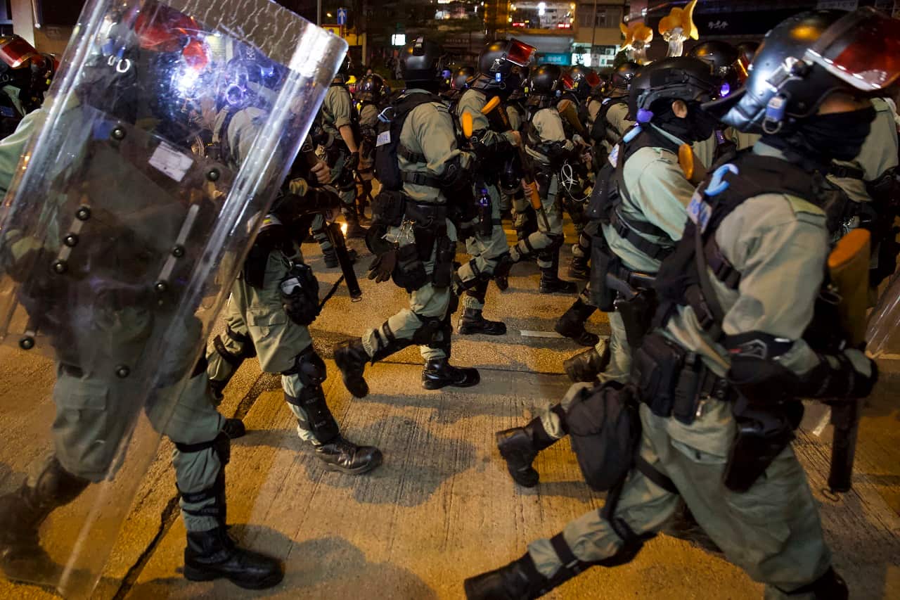 Riot police advance along a street in Hong Kong on Saturday.