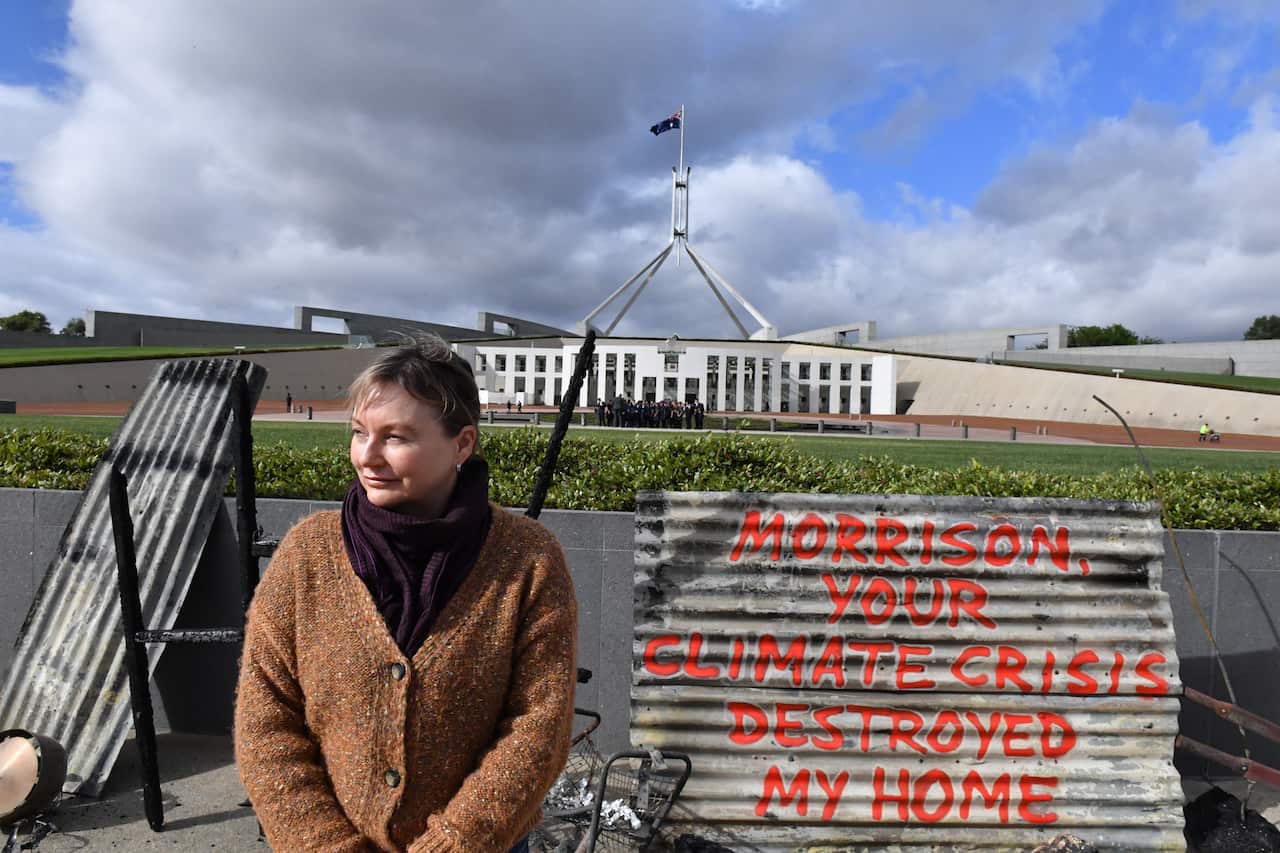 Melinda Plesman delivered her climate message to Canberra by scrawling it across the remains of her fire-ravaged home.