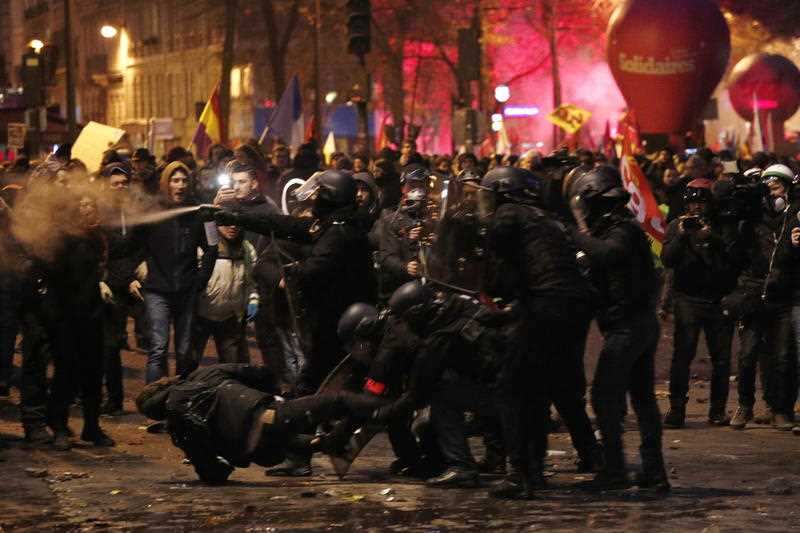 French riot police clash with protesters during a demonstration against pension reforms in Paris, France, 5 December 2019