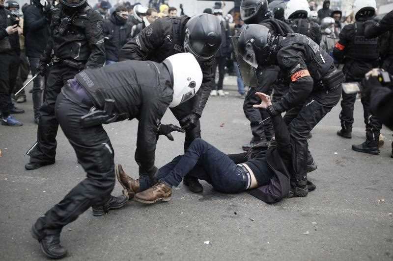People take part in a demonstration against the pension overhauls, in Paris, on December 5, 2019 as part of a nationwide strike