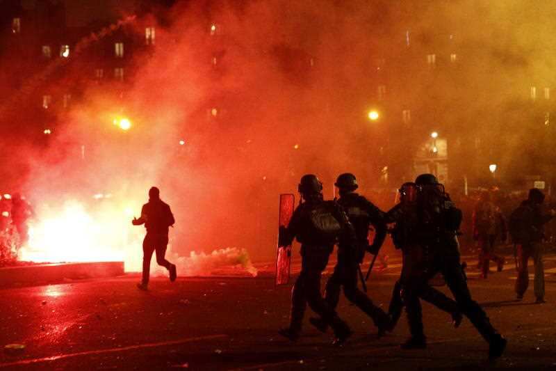 French riot police clash with protesters on Nation Square during a demonstration against pension reforms in Paris