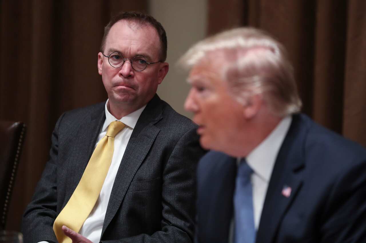 Then-White House chief of staff Mick Mulvaney listens as President Donald Trump speaks at a luncheon in the Cabinet Room of the White House in  December 2019.  
