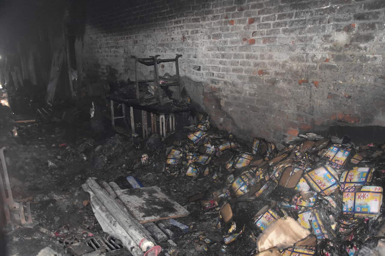 Charred goods are seen inside a factory that caught fire in New Delhi, India.