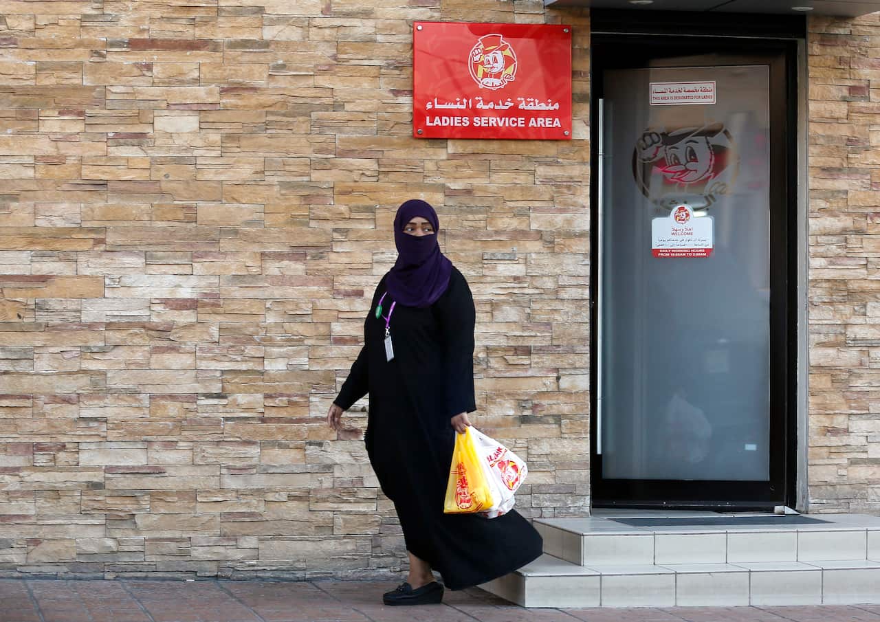 A woman leaves a ladies only service area at a restaurant in Jiddah, Saudi Arabia.