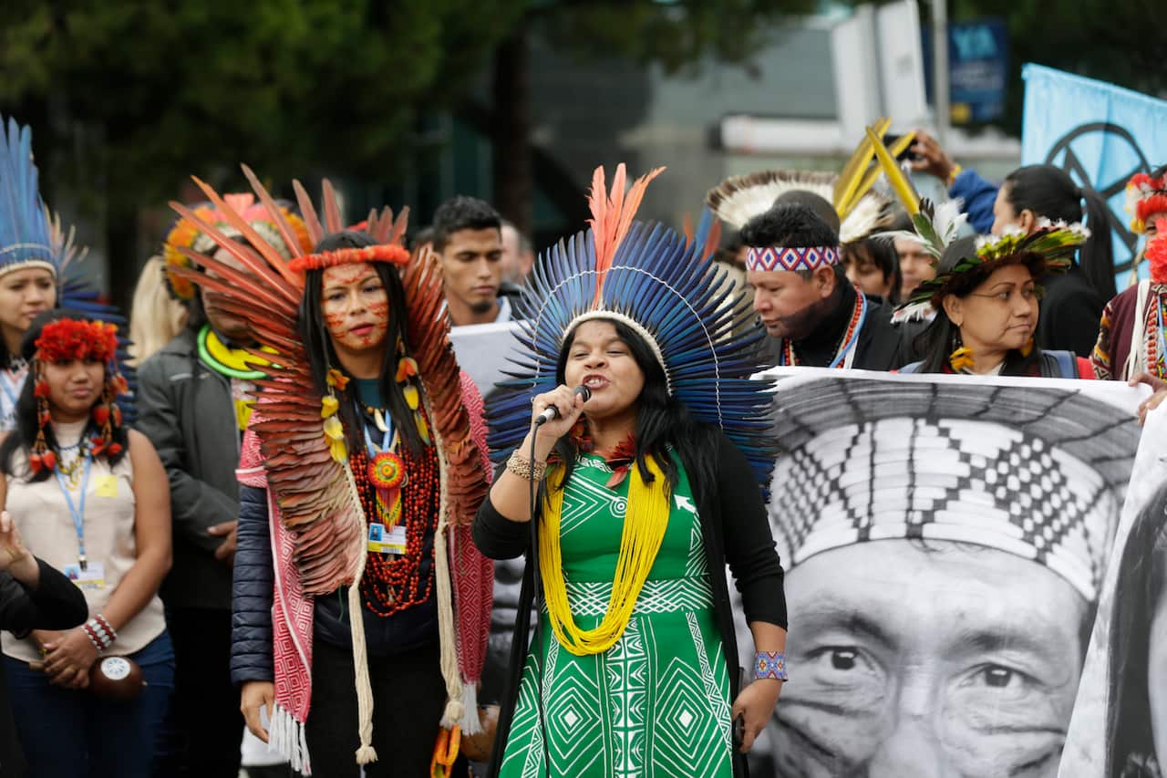 Indigenous leader Sonia Guajajara speaks alongside Indigenas activists in a protest outside the COP25 Climate summit.