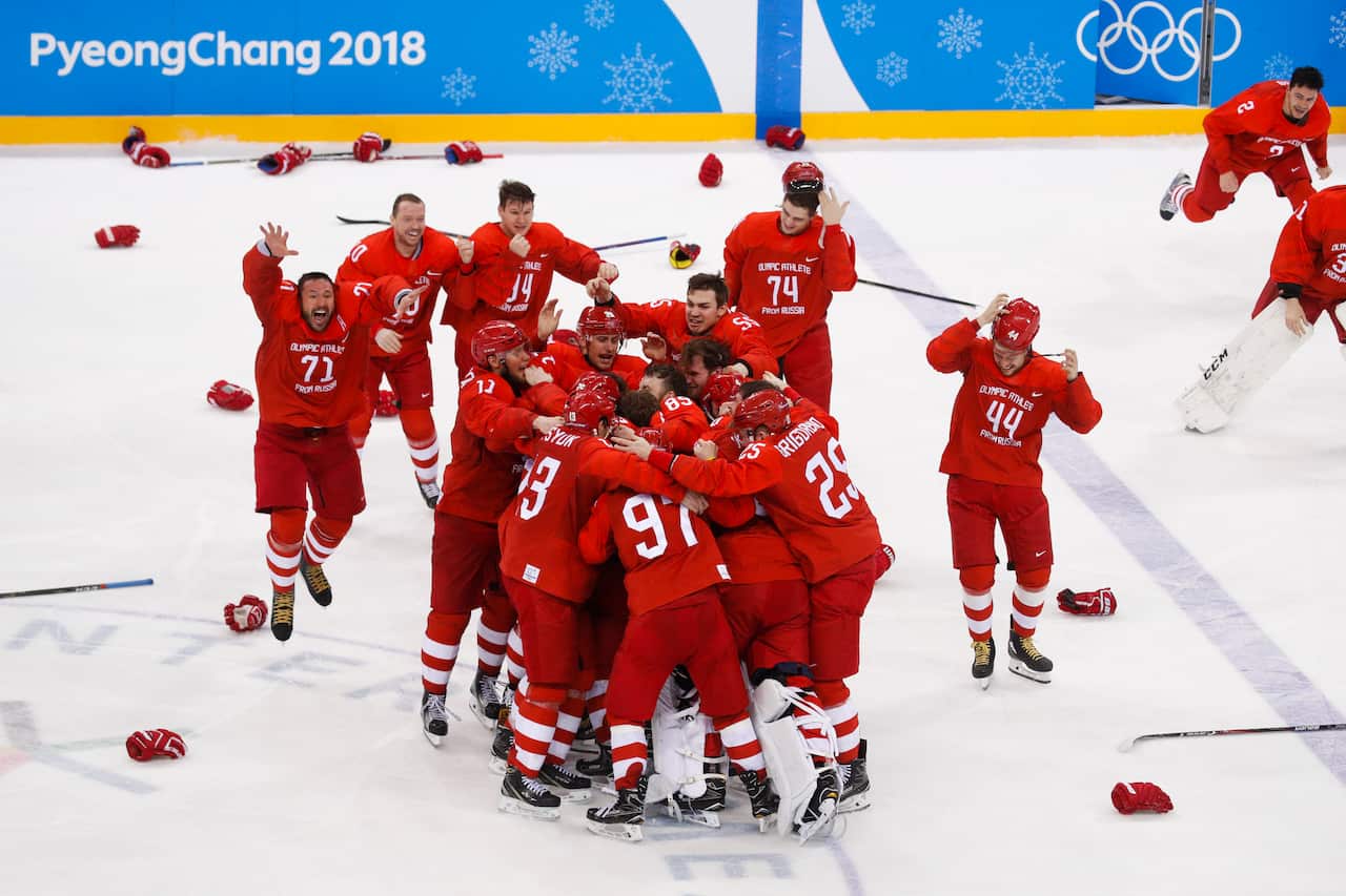 Olympic athletes from Russia celebrate after winning the men's gold medal hockey game at the 2018 winter olympics.