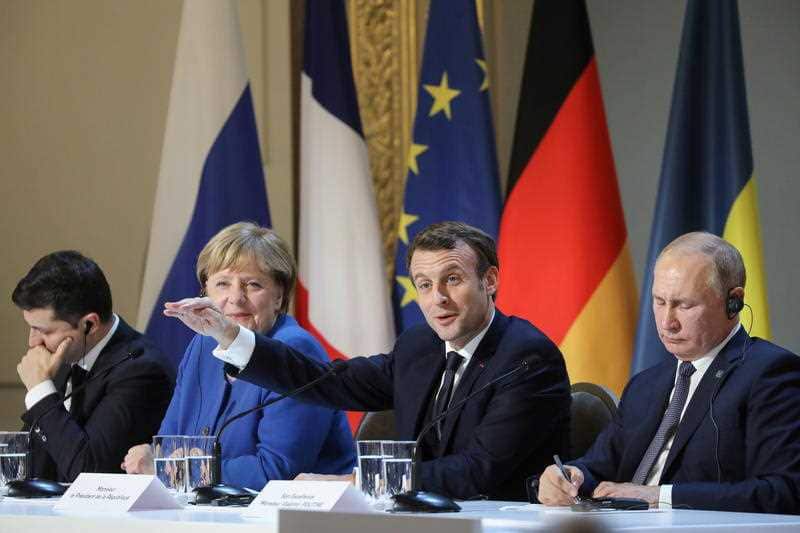 Ukrainian President Volodymyr Zelensky, German Chancellor Angela Merkel, French President Emmanuel Macron and Russian President Vladimir Putin address the media