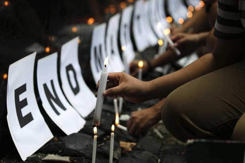 In this May 23, 2018, file photo, student protesters light candles to call on the government to end martial law in Mindanao province