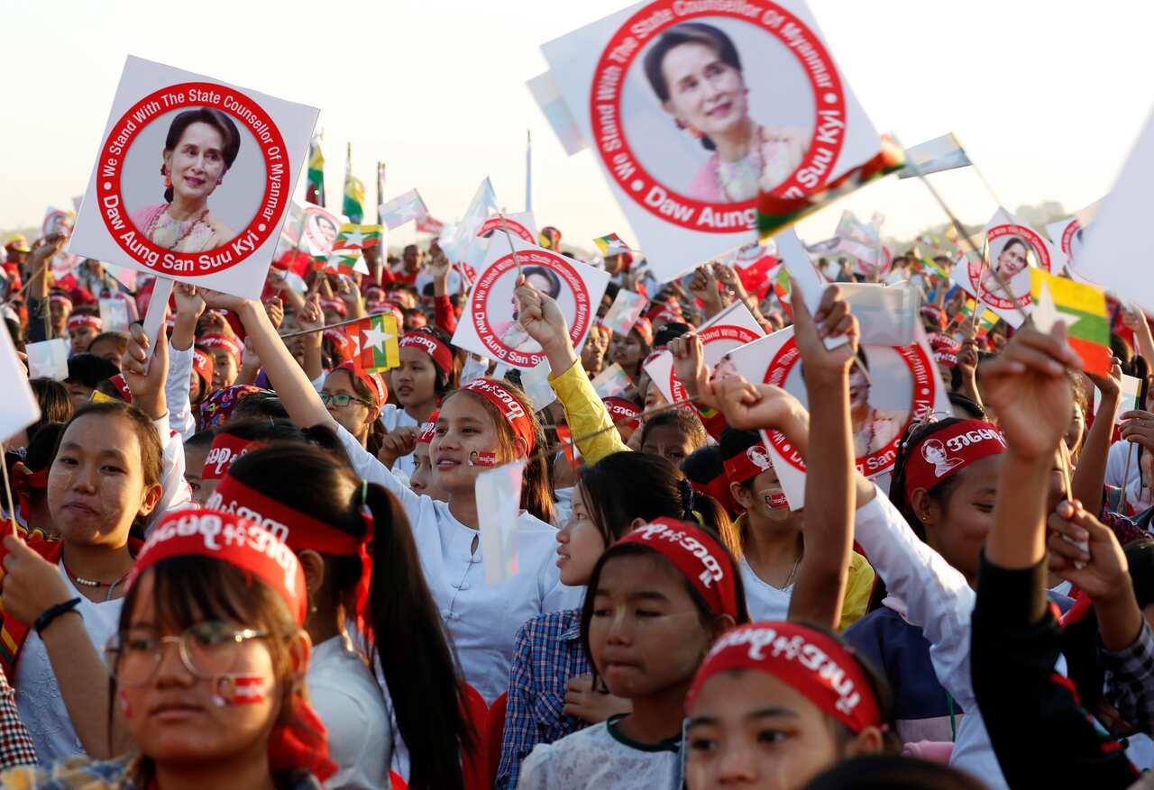 High School students hold images of Myanmar State Counsellor Aung San Suu Kyi during a rally in Mandalay, Myanmar, 10 December 2019.