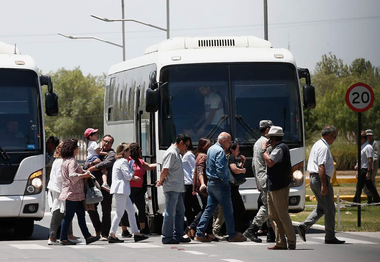 Relatives of passengers of a missing military plane arrive by bus to the Cerrillos airbase in Santiago, Chile.