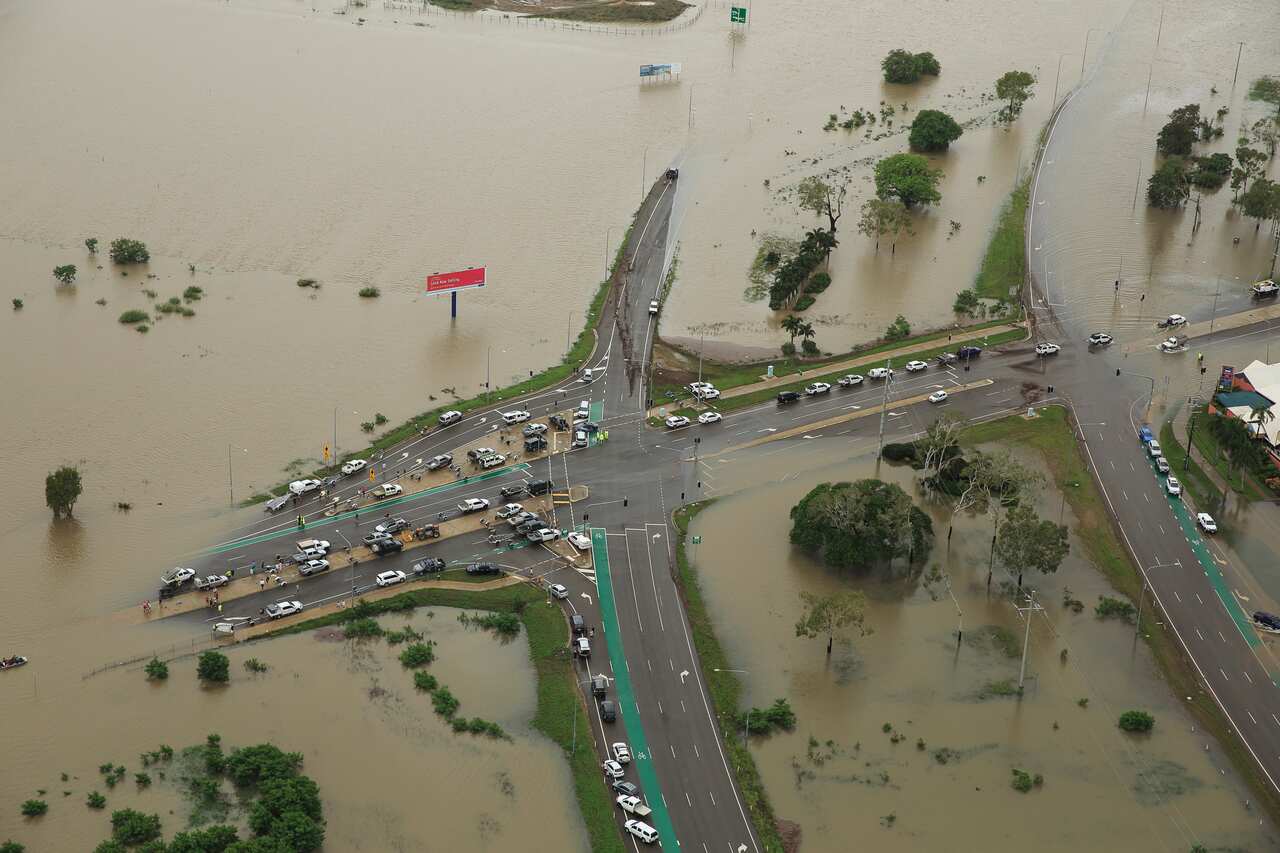 Stranded vehicles are seen from above as floodwater engulfs the intersection of Stuart Drive and the Bruce Highway in Townsville, Monday, 4 February, 2019. 