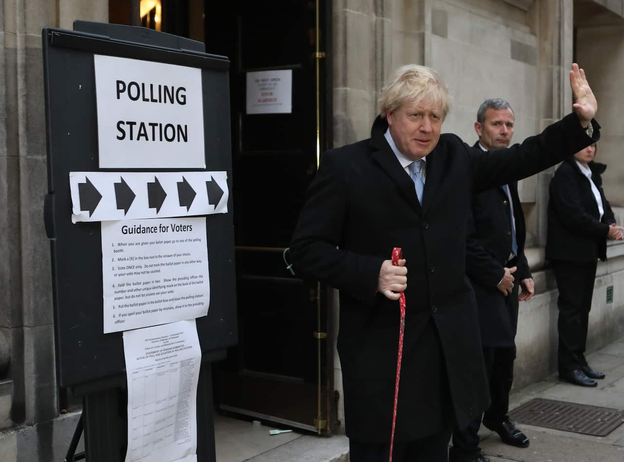 Prime Minister Boris Johnson leaves the polling station with his dog Dilyn after casting his vote in the 2019 General Election.