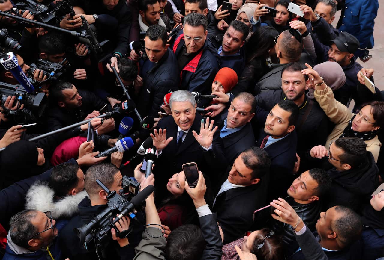 Algerian presidential candidate and former prime minister Ali Benflis speaks to the media after casting his ballot.